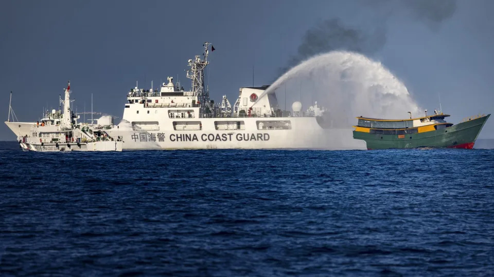 A Chinese Coast Guard ship fires a water cannon at the Philippine vessel Unaizah near the Second Thomas Shoal in March 2024. (Ezra Acayan/Getty Images)