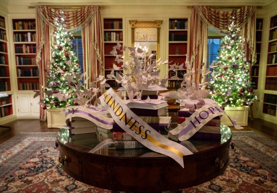 The White House Library decorated for Christmas in 2021 with ribbons that say "Hope," "Kindness," and "Joy."