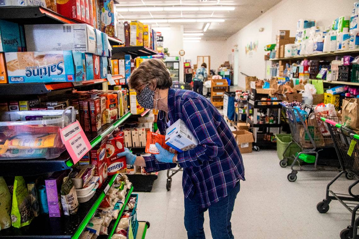 Carol Anne Moehring, a volunteer at Dorcas Ministries Food Pantry in Cary, gathers groceries for a family in need Friday, Dec. 18, 2020.