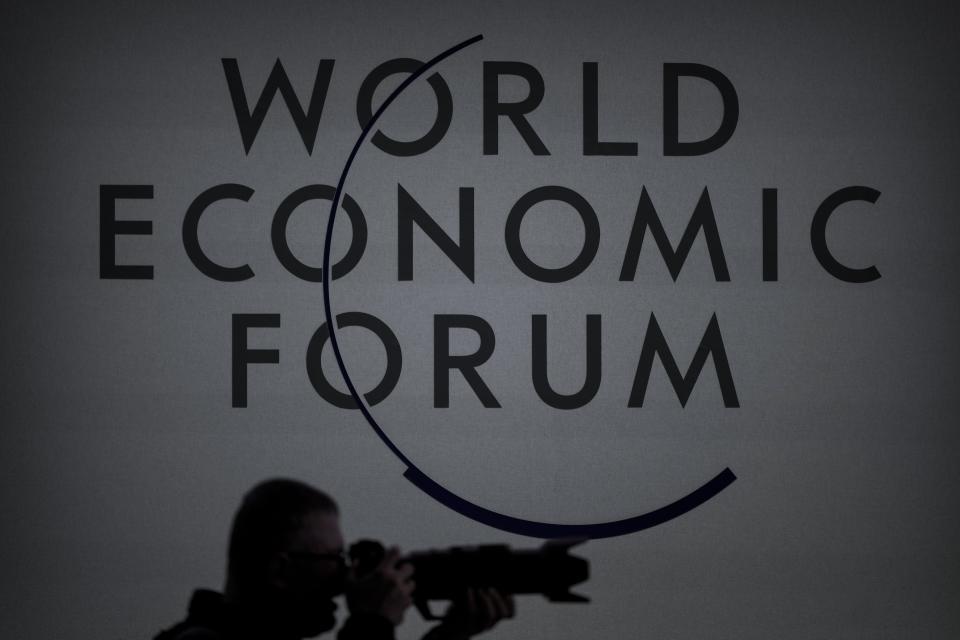 A photographer takes a picture at the World Economic Forum in Davos, Switzerland, Thursday, Jan. 18, 2024. The annual meeting of the World Economic Forum is taking place in Davos from Jan. 15 until Jan. 19, 2024. (AP Photo/Markus Schreiber)