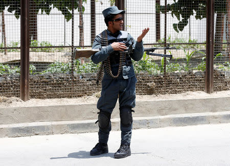 An Afghan police officer keeps watch at the site of a suicide attack in Kabul, Afghanistan June 4, 2018.REUTERS/Omar Sobhani