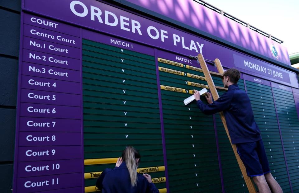 Ground staff update the order of play for day one of Wimbledon 2022 (John Walton/PA) (PA Wire)