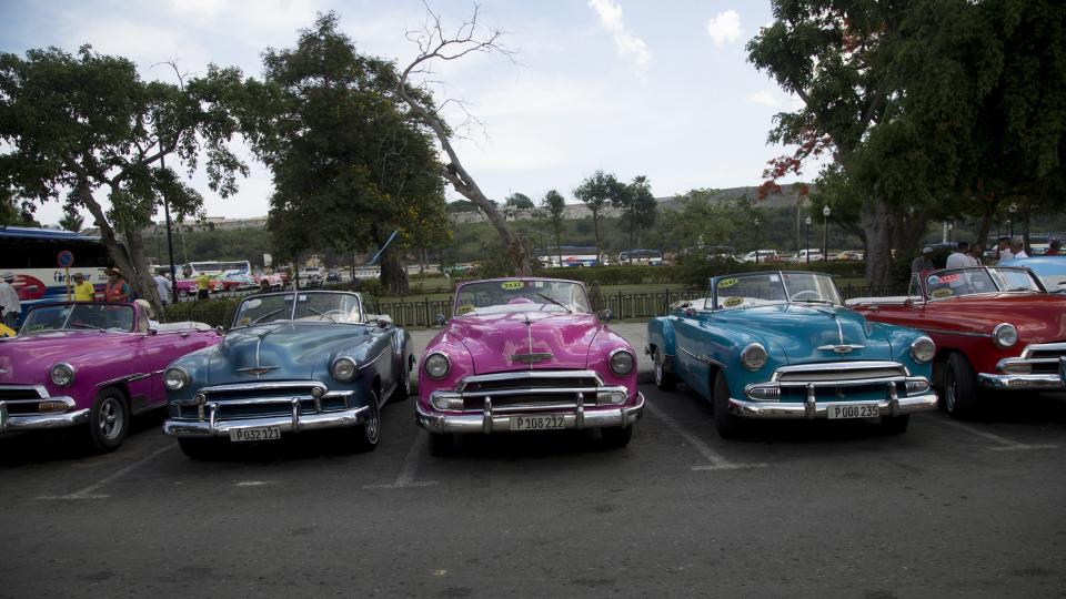 Classic American cars sit parked as their drivers await tourists in Havana, Cuba, Wednesday, June 5, 2019. Drivers of classic cars, owners of private restaurants, guides, handicrafts vendors and owners of rooms for rent will be among the most affected by the Trump administration’s new restrictions on travel to Cuba. (AP Photo/Ismael Francisco)