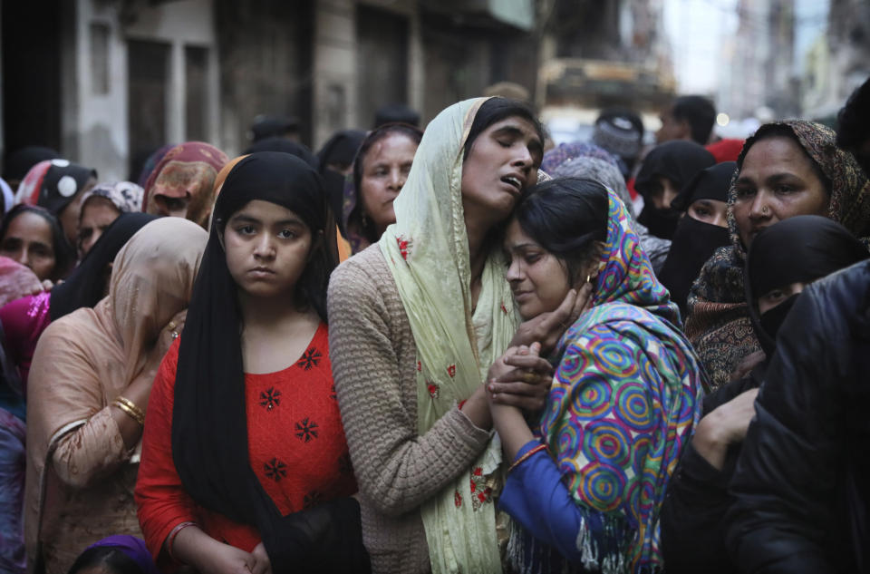 FILE- In this Thursday, Feb. 27, 2020, file photo, relatives and neighbors wail near the body of Mohammad Mudasir, 31, who was killed in communal violence in New Delhi, India. Facebook in India has been selective in curbing hate speech, misinformation and inflammatory posts, particularly anti-Muslim content, according to leaked documents obtained by The Associated Press, even as the internet giant's own employees cast doubt over the motivations and interests. (AP Photo/Manish Swarup, File)