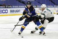 St. Louis Blues' Mike Hoffman (68) and San Jose Sharks' Fredrik Handemark (37) chase after a loose puck during the second period of an NHL hockey game Monday, Jan. 18, 2021, in St. Louis. (AP Photo/Jeff Roberson)