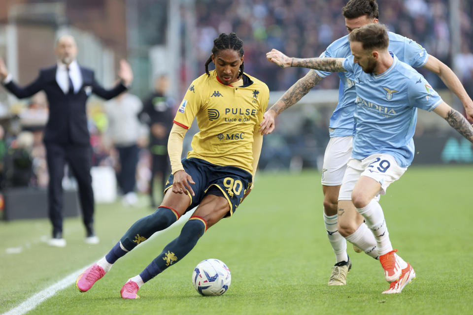 Genoa's Djed Spence, left, fights for the ball with Lazio's Manuel Lazzari during the Serie A soccer match between Genoa and Lazio at the Luigi Ferraris Stadium in Genoa, Italy, Friday, April 19, 2024. (Tano Pecoraro/LaPresse via AP)