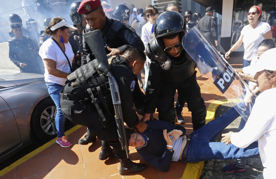 An anti-government protester is dragged away and arrested by police as security forces disrupt an opposition march coined "United for Freedom" in Managua, Nicaragua, Sunday, Oct. 14, 2018. Anti-government protests calling for President Daniel Ortega's resignation are ongoing since April, triggered by a since-rescinded government plan to cut social security pensions. Ortega said opponents will have to wait until his term ends in 2021. (AP Photo/Alfredo Zuniga)