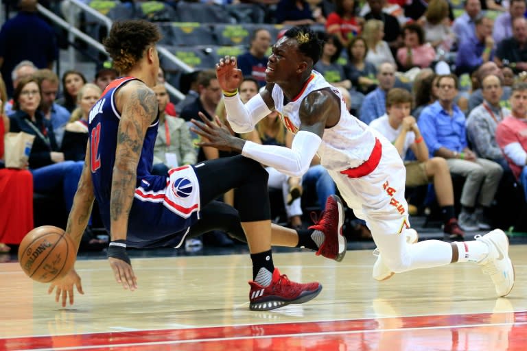 Despite being fouled by the Washington Wizards' Kelly Oubre, Dennis Schroder (R) scored 18 points in the Atlanta Hawks 111-101 win