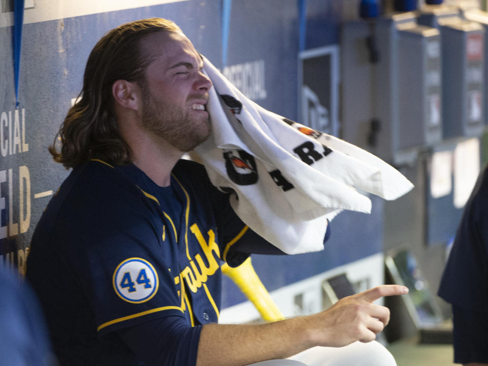 Milwaukee Brewers starting pitcher Corbin Burnes dries off between the sixth and seventh innings of a baseball game against the Cleveland Indians in Cleveland, Saturday, Sept. 11, 2021. (AP Photo/Phil Long)