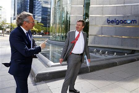 Belgian Minister for Public Enterprises and Development Cooperation Jean-Pascal Labille (L) talks with of Didier Bellens, chief executive officer of Belgium's telecom operator Belgacom (R) after a news conference at Belgacom headquarters in Brussels September 16, 2013. REUTERS/Yves Herman