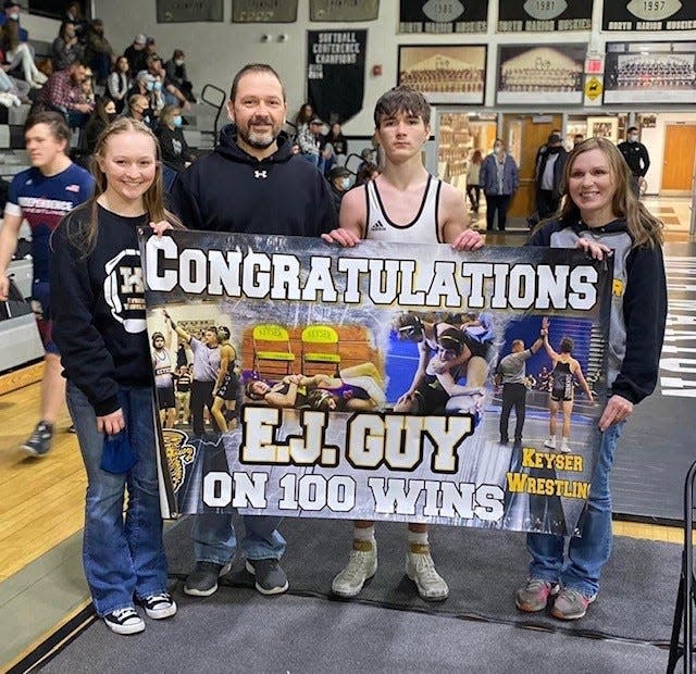 Keyser wrestler E.J. Guy poses with his sister Marissa, father Eric, and mother Missy after earning his 100th career win last Saturday.