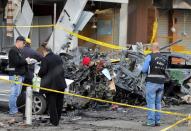 Lebanese forensic experts and Army soldiers inspect the site of a car bomb that targeted Beirut's southern suburb of Haret Hreik on January 3, 2014