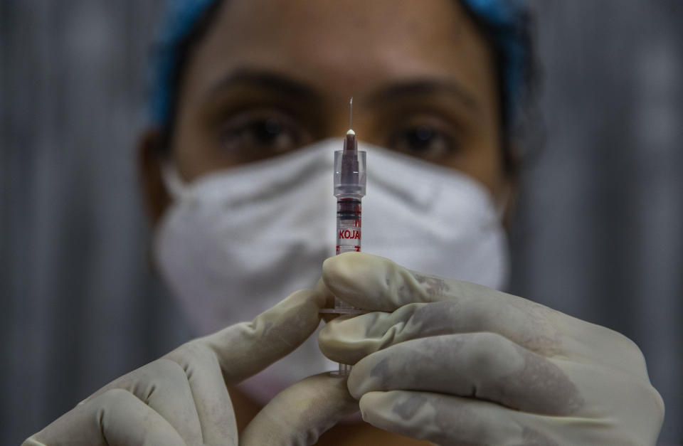 A health worker checks a syringe before performing a trial run of COVID-19 vaccine delivery system in Gauhati, India, Friday, Jan. 8, 2021. India will kick off the coronavirus vaccination drive on Jan. 16 to stem the pandemic in the world’s second-most populous country. A Health Ministry statement says that priority will be given to the healthcare workers and the frontline workers, estimated around 30 million. (AP Photo/Anupam Nath)