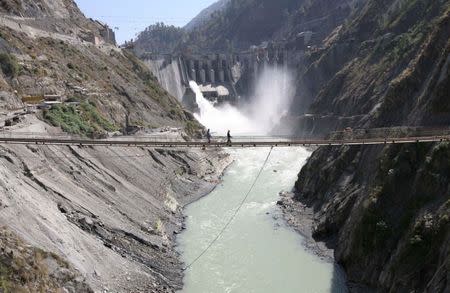 Labourers walk on a bridge near the newly inaugurated 450-megawatt hydropower project located at Baglihar Dam on the Chenab river which flows from Indian Kashmir into Pakistan, at Chanderkote, about 145 km (90 miles) north of Jammu October 10, 2008. REUTERS/Amit Gupta