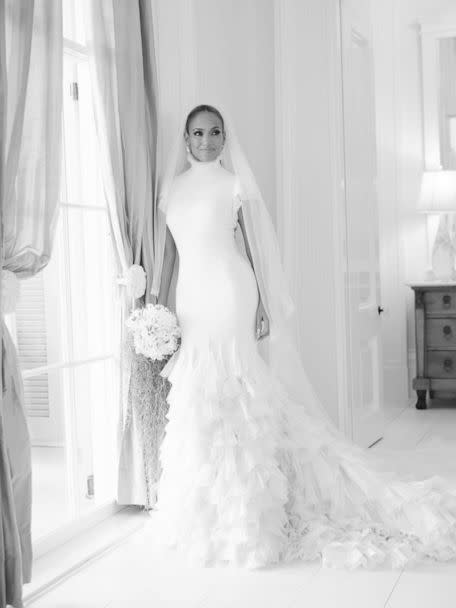 Jennifer Lopez poses for a photo in her wedding dress by Ralph Lauren. (Courtesy of John Russo)