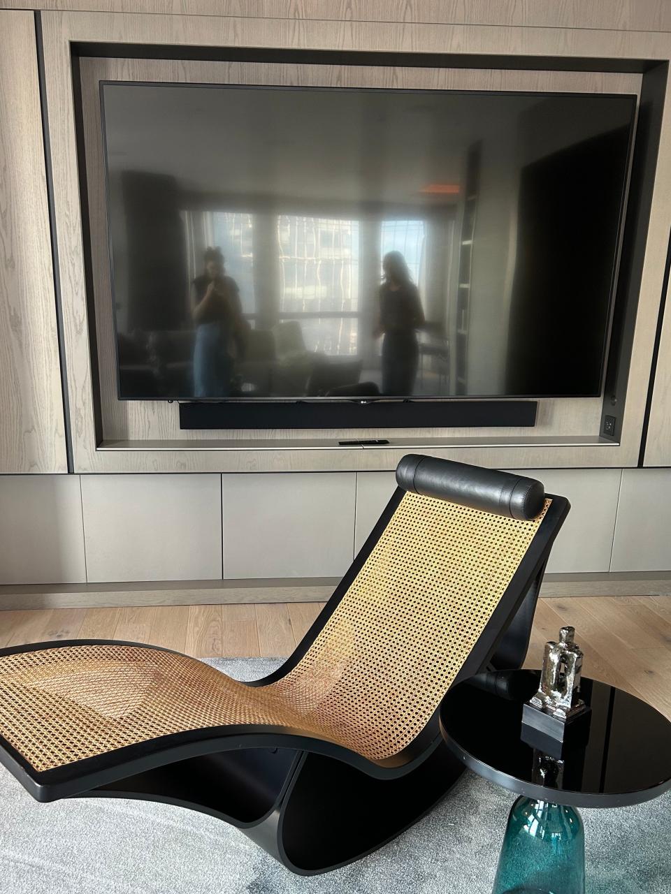 A chair, side table, and television in the Equinox Hotel penthouse.