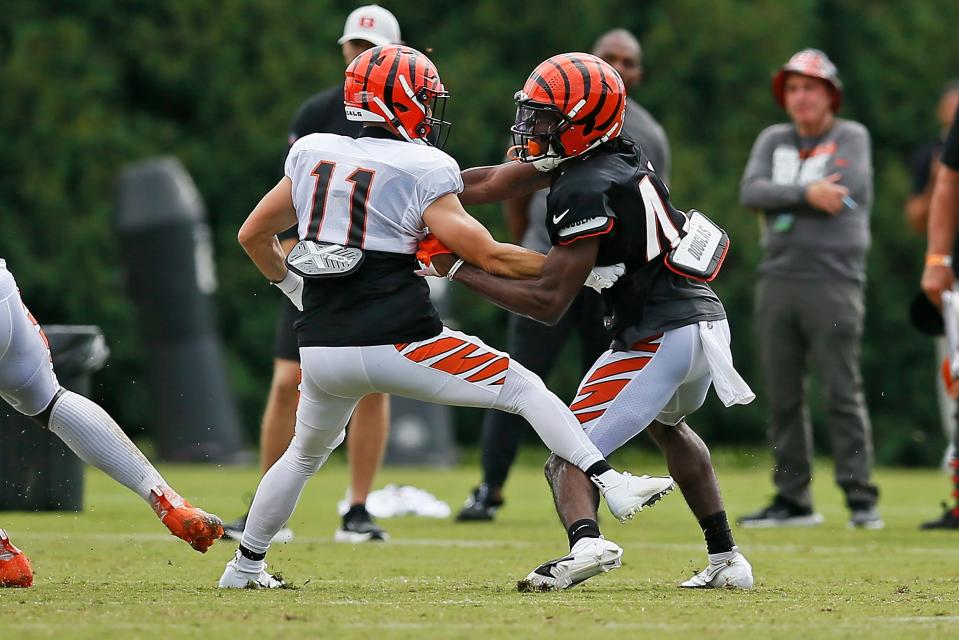 Cincinnati Bengals wide receiver Trent Taylor (11) and  cornerback Allan George (42) clash during a preseason training camp practice at Paul Brown Stadium in downtown Cincinnati on Friday, Aug. 5, 2022.