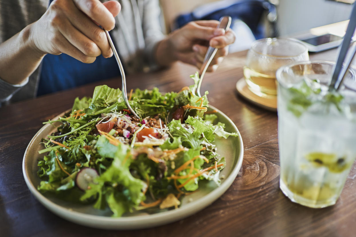 Japanese woman eating a vegan lunch at a vegan cafe