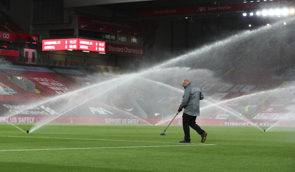 Un empleado da mantenimiento a la cancha previo al partido entre Liverpool y Arsenal por la Copa de la Liga inglesa, en el estadio Anfield de Liverpool, el jueves 1 de octubre de 2020. (Peter Byrne/Pool vía AP)