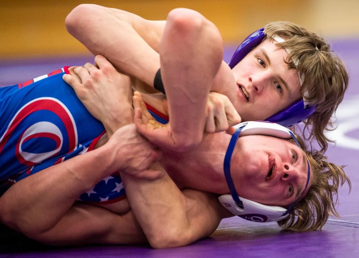 South's Hunter Fender wrestles Owen Valley's Conner Rogers in the 145 weight class during the Bloomington South versus Owen Valley wrestling match at Bloomington High School South on Wednesday, Jan. 4, 2023.