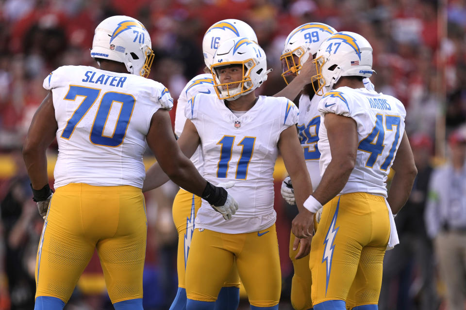 Los Angeles Chargers place kicker Cameron Dicker (11) is congratulated by teammates after making a 55-yard field goal during the first half of an NFL football game against the Kansas City Chiefs Sunday, Oct. 22, 2023, in Kansas City, Mo. (AP Photo/Charlie Riedel)