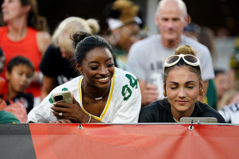 Olympian Simone Biles, left, talks with a member of the stadium staff in the second quarter during the Packers' preseason game against the Bengals Friday at Paycor Stadium in Cincinnati. Biles is married to Packers safety Jonathan Owens.