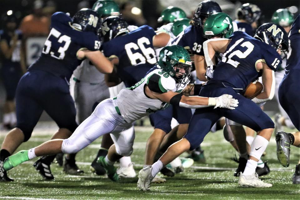 Yorktown football's Jayce Key dives for a tackle in the team's sectional championship game at Norwell High School on Friday, Nov. 4, 2022.