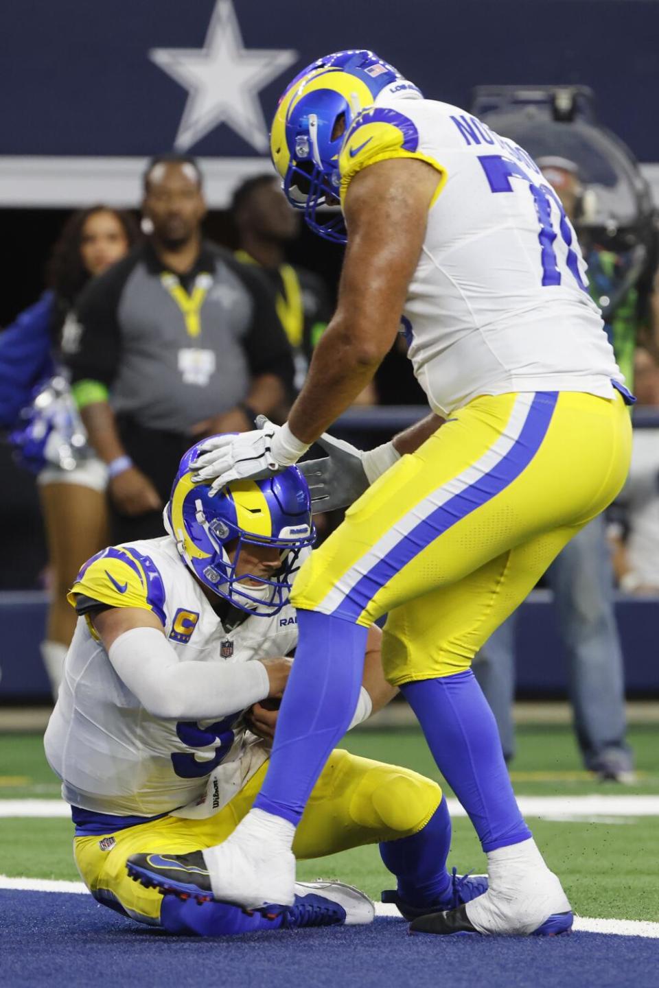 Matthew Stafford (9) and Joe Noteboom (70) celebrate after Stafford scored on a two-point conversion against Dallas.