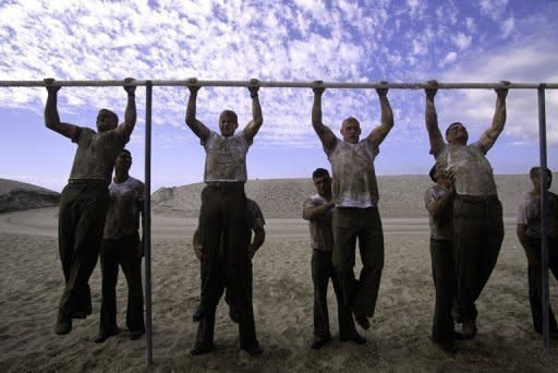 Fatigued Navy Seals struggle to do pull ups on the beach at Hell Week training in Coronado, California. Defense Secretary Robert Gates voiced concern Thursday about the safety of the US Navy SEAL team that killed Osama bin Laden and said security would be stepped up for the commandos