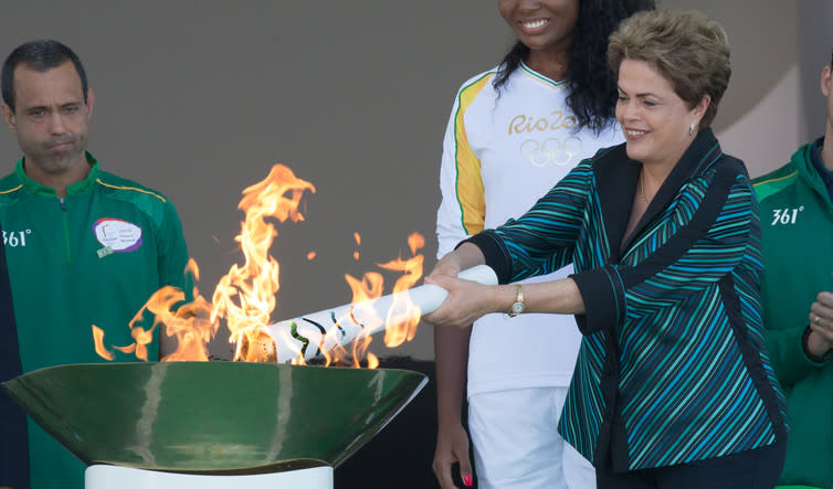 <span class="caption">Rousseff receives the Olympic Flame in Brasilia.</span> <span class="attribution"><a class="link " href="http://fotospublicas.com/lanterna-contendo-a-chama-olimpica-chega-ao-aeroporto-internacional-de-brasilia/" rel="nofollow noopener" target="_blank" data-ylk="slk:Lula Marques/ Agência PT;elm:context_link;itc:0;sec:content-canvas">Lula Marques/ Agência PT</a>, <a class="link " href="http://creativecommons.org/licenses/by-nc/4.0/" rel="nofollow noopener" target="_blank" data-ylk="slk:CC BY-NC;elm:context_link;itc:0;sec:content-canvas">CC BY-NC</a></span>