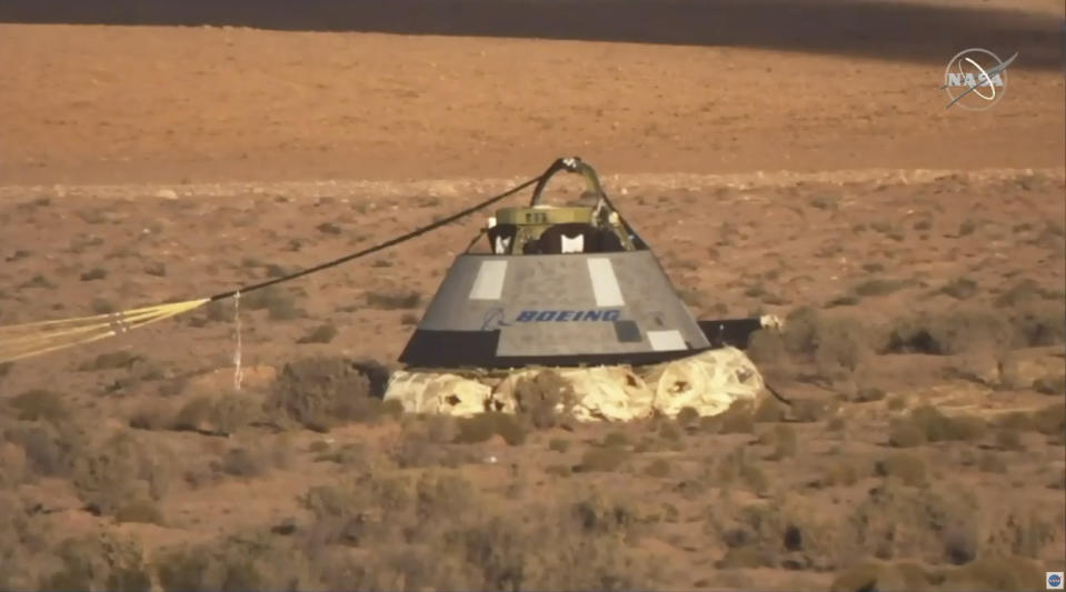 In this image made from a video provided by NASA the Starliner capsule rests on the ground after a test of Boeing's crew capsule's launch abort system in White Sands Missile Range in N.M., on Monday, Nov. 4, 2019. The capsule carried no astronauts Monday morning, just a test dummy. (NASA via AP)