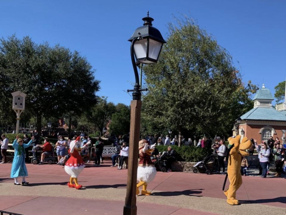 Pluto, Donald Duck, Daisy Duck, and Wendy (from Peter Pan) greeting guests as part of one of the impromptu parades the author saw during his visit.