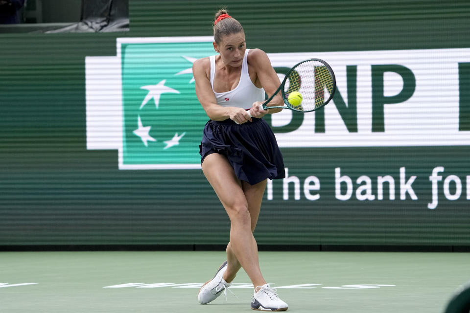 Marta Kostyuk, of Ukraine, returns to Iga Swiatek, of Poland, during a semifinal match at the BNP Paribas Open tennis tournament, Friday, March 15, 2024, in Indian Wells, Calif. (AP Photo/Mark J. Terrill)