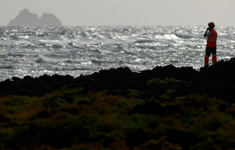 Rescue workers search for bodies after a boat with 46 migrants from the Maghreb region capsized in the beach of Orzola