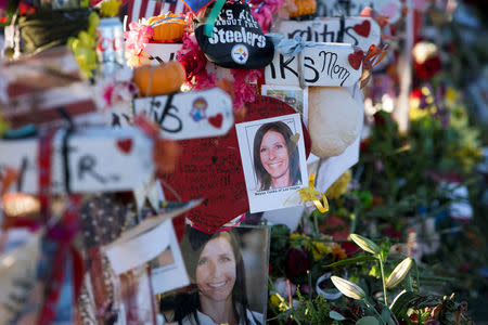 Photos of October 1 mass shooting victim Neysa Tonks is shown on a wooden cross in the median of Las Vegas Boulevard South near the "Welcome to Las Vegas" sign in Las Vegas, Nevada U.S. October 9, 2017. REUTERS/Las Vegas Sun/Steve Marcus