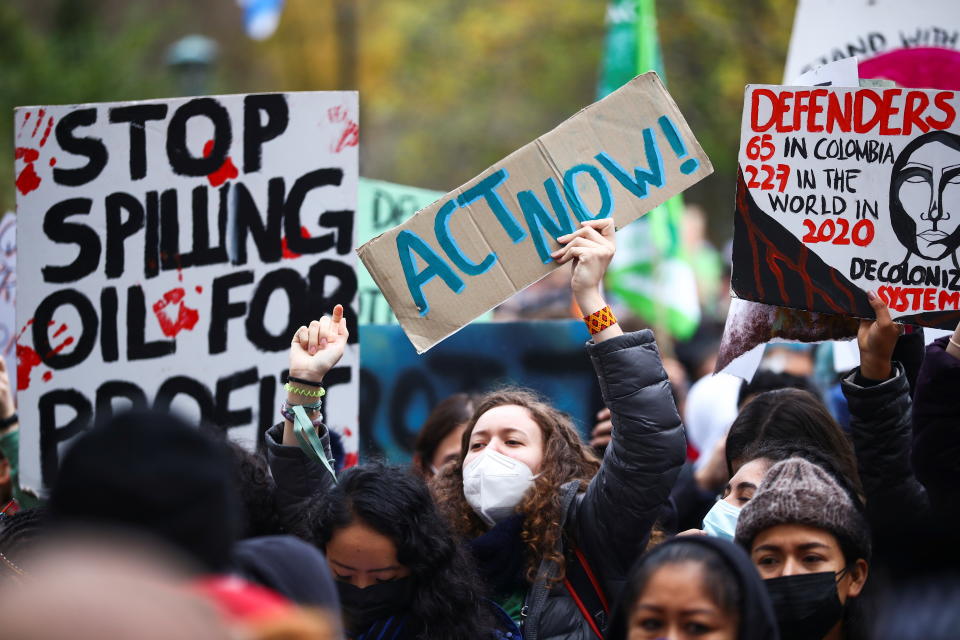 Demonstrators hold placards at a Fridays for Future march during the UN Climate Change Conference (COP26), in Glasgow, Scotland, Britain, November 5, 2021. REUTERS/Hannah McKay