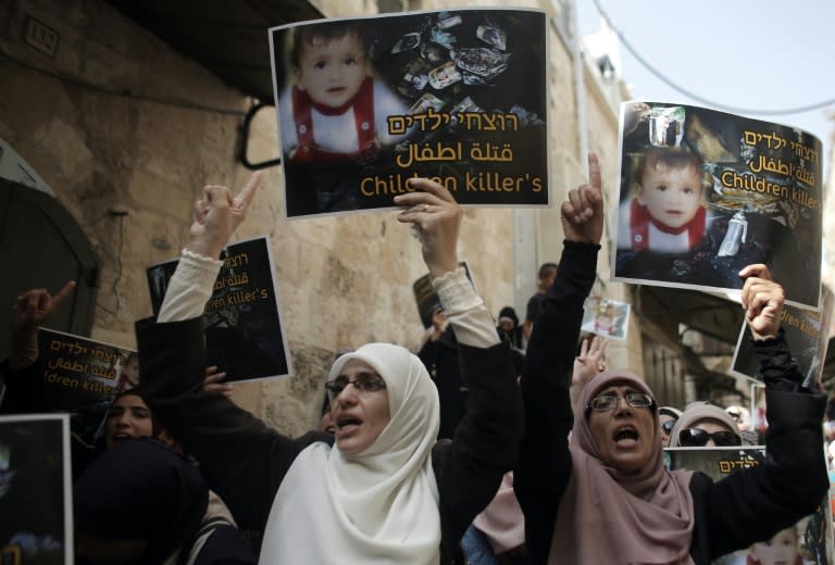 Palestinians take part in a protest against the death of the 18-month-old child killed in an arson attack in the occupied West Bank, on August 2, 2015