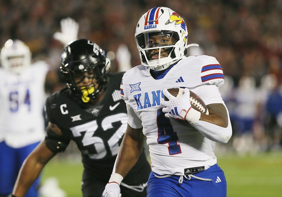 Kansas Jayhawks running back Devin Neal (4) runs for a touchdown against Iowa State during the first quarter at Jack Trice Stadium on Saturday, Nov. 4, 2023, in Ames, Iowa.