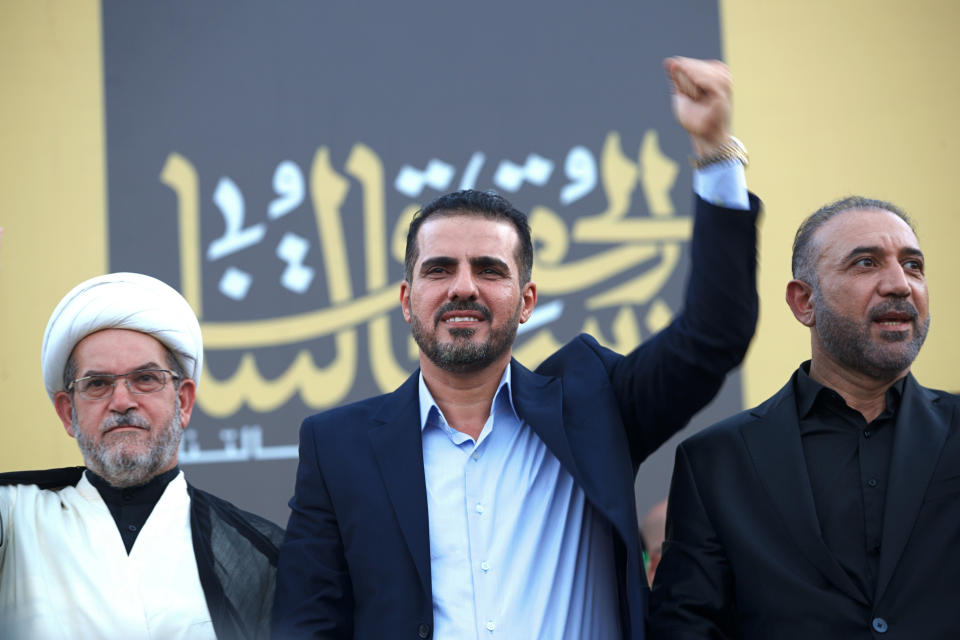 Hussein Muanis, the leader of a political movement called "Harakat Huqooq," Arabic for Rights Movement, center, salutes his supporters at an election rally before the upcoming parliamentary elections in Baghdad, Iraq, Friday, Sept. 3, 2021. Muanis is the leader of Kataeb Hezbollah, one of the most hard-line and powerful militias with close ties to Iran, who once battled U.S. troops. He is the first to be openly affiliated with Kataeb Hezbollah or Hezbollah Brigades, signaling the militant group’s formal entry into politics. (AP Photo/Hadi Mizban)