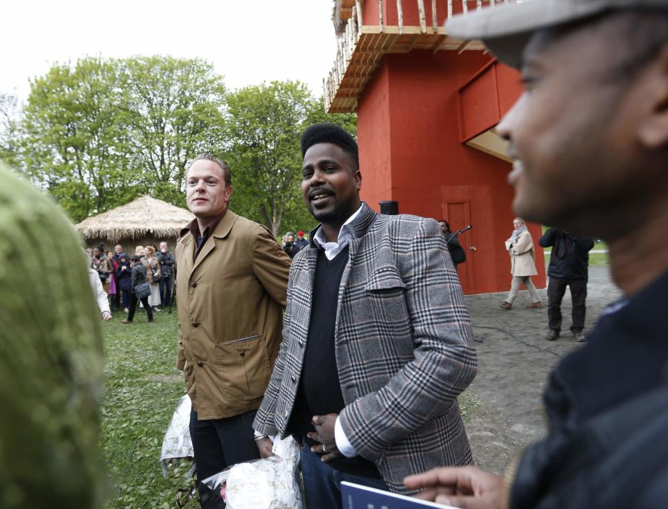 Artists Lars Cuzner (L) and Mohamed Ali Fadlabi attend the opening of the "Congo Village" in Oslo May 15, 2014. The two artists hope their "Congo Village" display will help erase what they say is Norwegians' collective amnesia about racism. The Congo Village - which 100 years ago displayed African tribes, attracting 1.4 million visitors over four months - will this time exhibit volunteers taking turns living on show in makeshift huts, resembling a traditional sub-Saharan village. Picture taken May 15, 2014. REUTERS/Lise Aserud/NTB Scanpix (NORWAY - Tags: SOCIETY) ATTENTION EDITORS - THIS IMAGE HAS BEEN SUPPLIED BY A THIRD PARTY. FOR EDITORIAL USE ONLY. NOT FOR SALE FOR MARKETING OR ADVERTISING CAMPAIGNS. NORWAY OUT. NO COMMERCIAL OR EDITORIAL SALES IN NORWAY. THIS PICTURE IS DISTRIBUTED EXACTLY AS RECEIVED BY REUTERS, AS A SERVICE TO CLIENTS