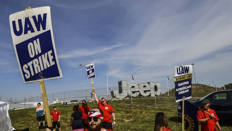 Matthew Gump, left, and other United Auto Workers walk the picket line during the auto workers strike on Thursday, Sept. 21, 2023, at the Stellantis Toledo Assembly Complex in Toledo, Ohio.