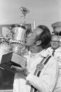 FILE - In this Feb. 13, 1971, file photo, Red Farmer kisses the trophy after winning the Permatex 300 stock car race at Daytona International Speedway in Daytona Beach, Fla. Farmer is a contender for NASCAR's 2021 Hall of Fame class, to be announced Tuesday, June 16, 2020. (AP Photo/George Brich, File)