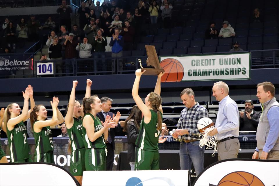 Members of the Ponaganset girls basketball team show off the championship trophy after winning the state title on Sunday.