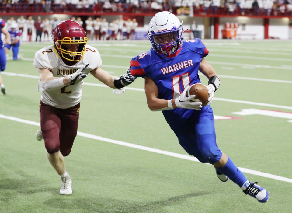 Warner's Jesiah Baum heads to the end zone against Deubrook Area's J.P. Rogness during the state Class 9A football championship on Thursday, Nov. 9, 2023 in Vermillion's DakotaDome. Warner won 76-54.