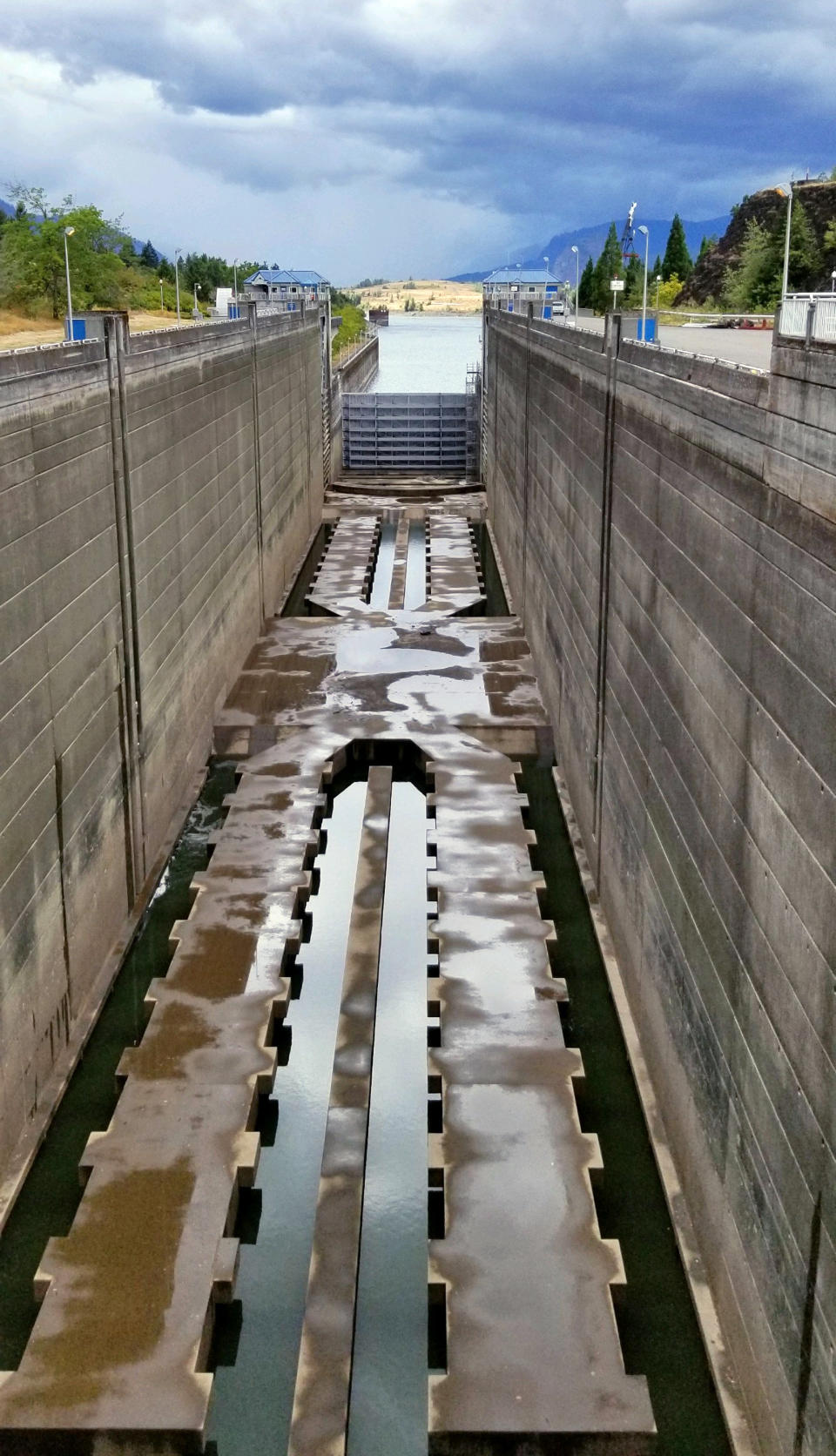 This Sunday, Sept. 8, 2019 photo provided by the U.S. Army Corps of Engineers shows a dry boat lock on the Bonneville Dam on the Columbia River that connects Oregon and Washington at Cascade Locks., Ore. A critical lock has shut down for repairs, meaning barges that shuttle millions of tons of wheat, wood and other inland goods to the Pacific Ocean for transport to Asia can't move. An official said Monday, Sept. 9, 2019 that a crack in the Bonneville Dam lock's concrete sill was discovered late last week. It's not clear when repairs will be complete. (Megan Innes/U.S. Army Corps of Engineers via AP)