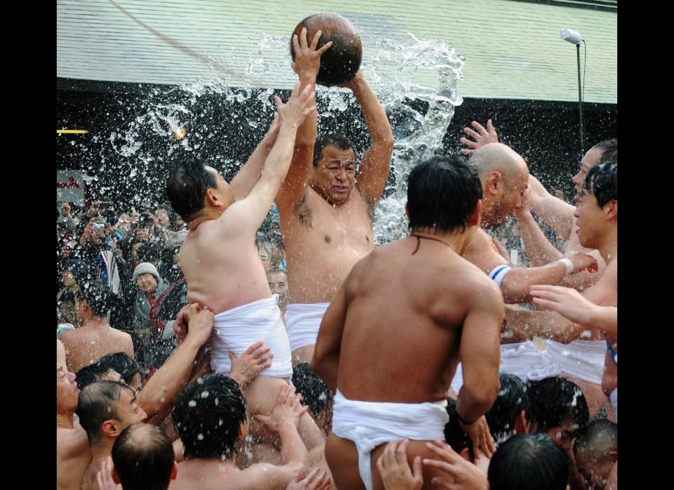 Naked men wearing only loincloths vie for a wooden treasure ball weighing eight kilos to bring good fortune, during the Tamaseseri festival at Hakozaki shrine in Fukuoka, on Japan's southern island of Kyushu on Jan. 3, 2012. Two teams of farmers and fishermen competed for the rich harvest or largest catch at a festival that dates back some 500 years. 