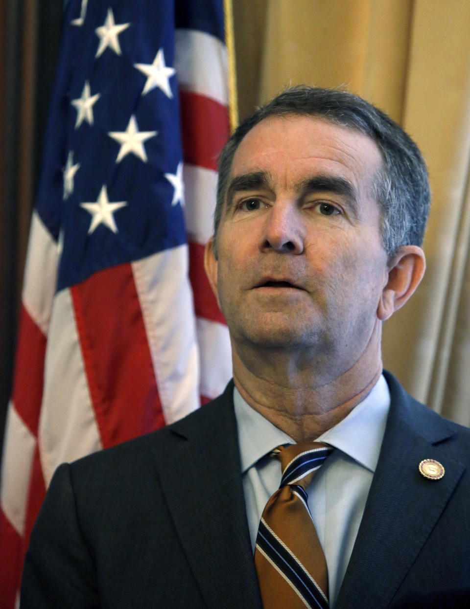 Gov. Ralph Northam prepares to adress a press conference at the State Capitol Monday, Jan. 6, 2020 where he previewed his voting legislative proposals, including removing Lee-Jackson Day as a state holiday and replacing it with election day. (Bob Brown/Richmond Times-Dispatch via AP)