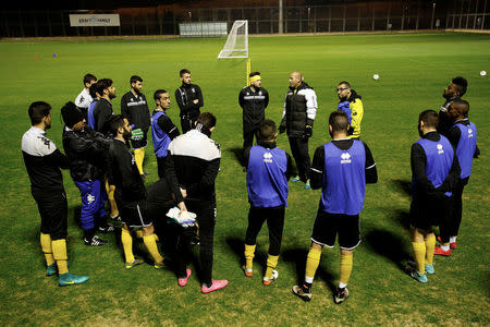 Betar Nordia Jerusalem players listen to their coach as they stand in a circle during a practice session at the team's training ground in Jerusalem, January 24, 2018. REUTERS/Amir Cohen