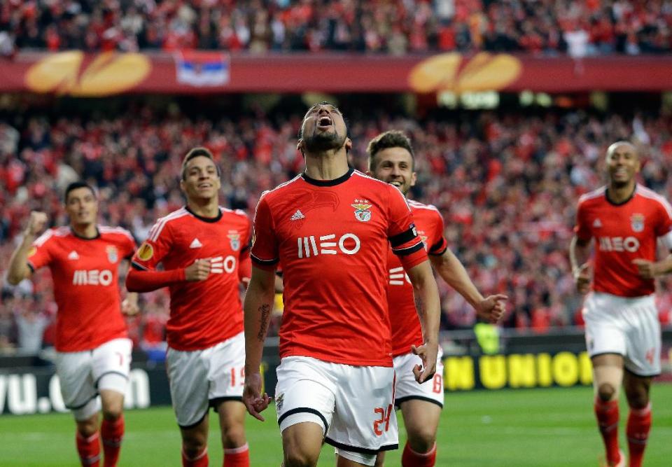 Benfica's Ezequiel Garay, center, celebrates after scoring the opening goal during the Europa League semifinal, first leg, soccer match between Benfica and Juventus Thursday, April 24 2014, at Benfica's Luz stadium in Lisbon. (AP Photo/Armando Franca)