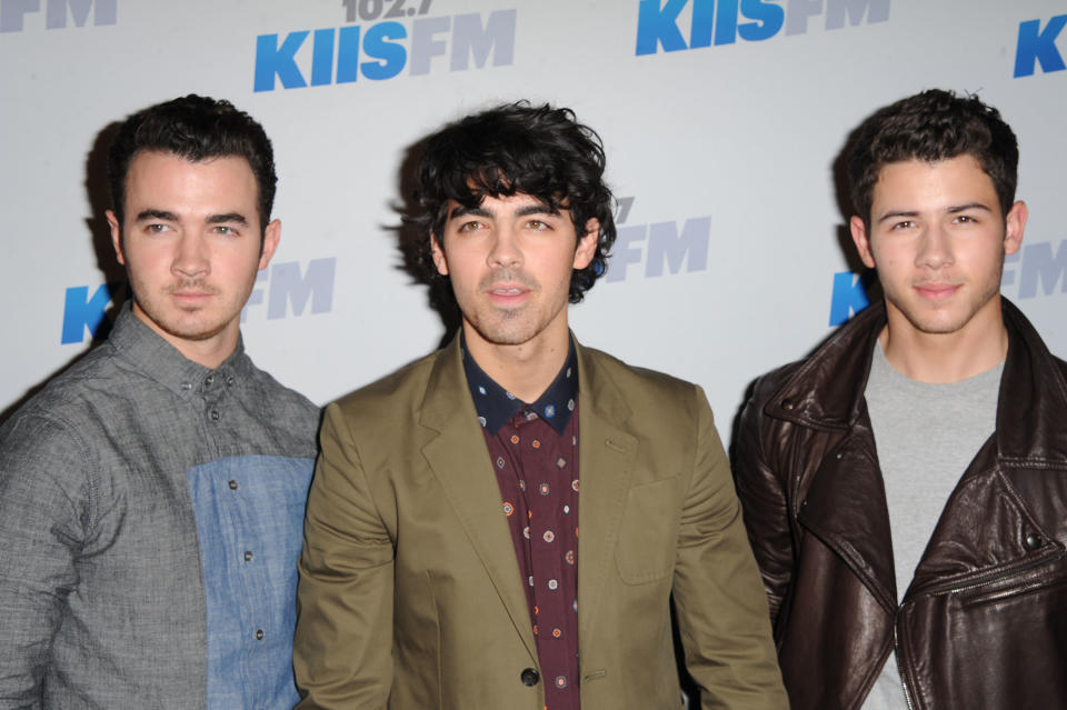 The Jonas Brothers, from left, Kevin, Joe and Nick arrives at KIIS FM's Jingle Ball at Nokia Theatre LA Live on Saturday, Dec. 1, 2012, in Los Angeles. (Photo by Katy Winn/Invision/AP)